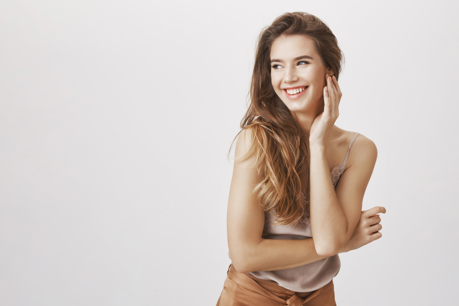 Beautiful woman applying makeup with professional brush